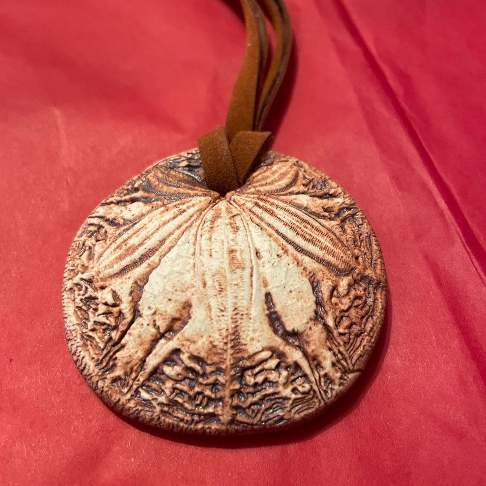 Used But On Good Condition Made Of Clay on a cord.